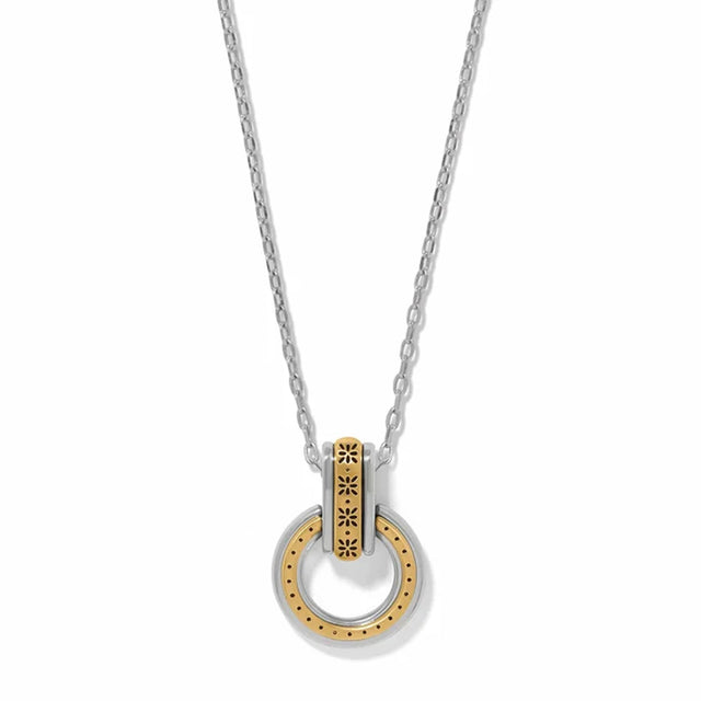 A silver and gold two-tone necklace featuring a circular pendant with a textured gold center and a silver outer ring, suspended from a delicate silver chain on a white background.