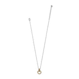 A delicate silver chain necklace with a small gold ring pendant, displayed against a solid white background.