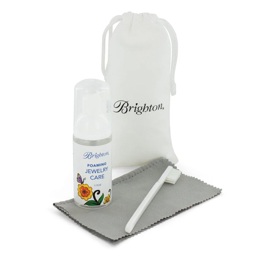 Jewelry care kit with bottle, cloth, and pouch on a white background