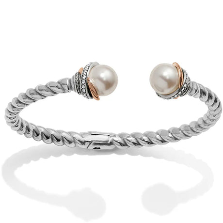 Silver bracelet with two pearls on a white background
