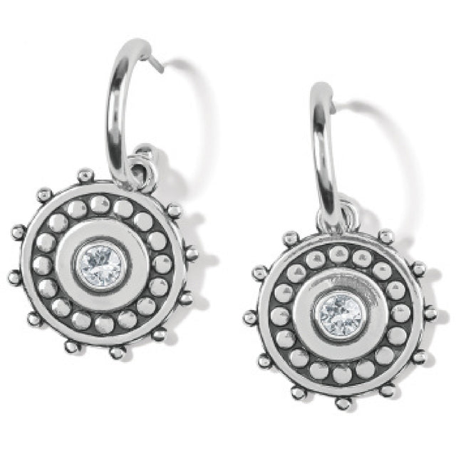 Silver earrings with circular design and clear gemstone on a white background