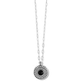Silver necklace with a round pendant featuring a black gemstone on a white background