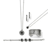 Silver jewelry set with necklace, ring, and bracelet on a white background