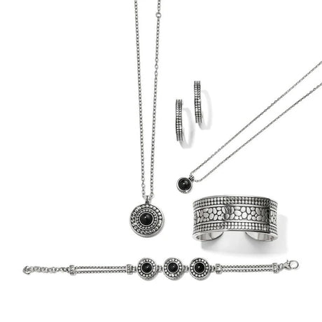 Silver jewelry set with necklace, ring, and bracelet on a white background