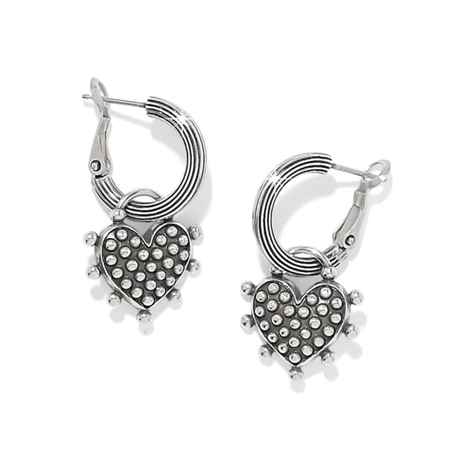 A pair of silver hoop earrings with textured heart-shaped charms covered in small clear rhinestones, shown on a clean white background.
