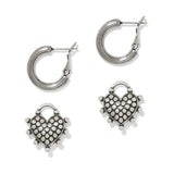 Silver heart-shaped hoop earrings on a white background