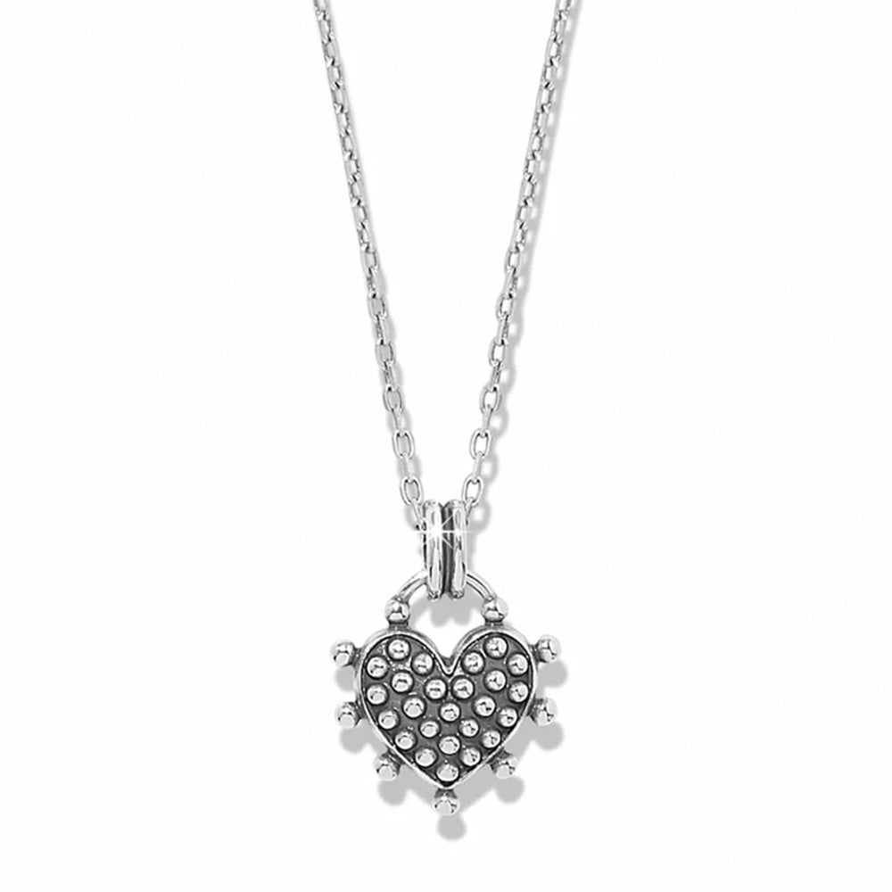 A silver heart-shaped pendant necklace featuring a pavé-set heart with small clear stones and a spiked border, suspended from a delicate silver chain against a white background.