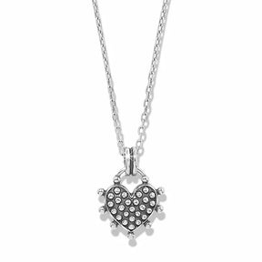A silver heart-shaped pendant necklace featuring a pavé-set heart with small clear stones and a spiked border, suspended from a delicate silver chain against a white background.