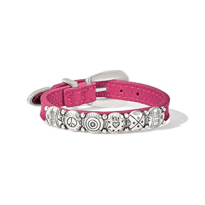 Pink bracelet with decorative metal plate on a white background
