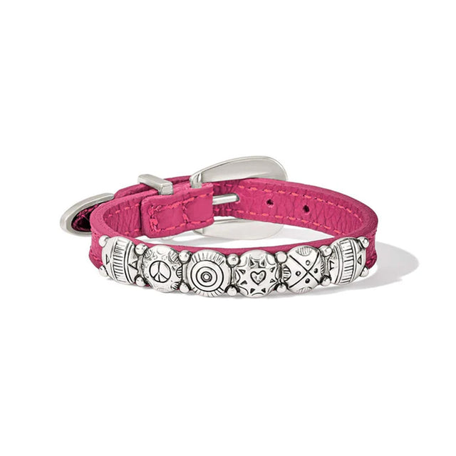 Pink bracelet with decorative metal plate on a white background