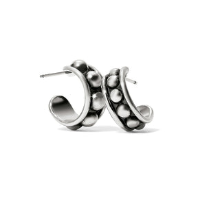 A pair of small post hoop earrings with tough stud accents, crafted in a silver color.