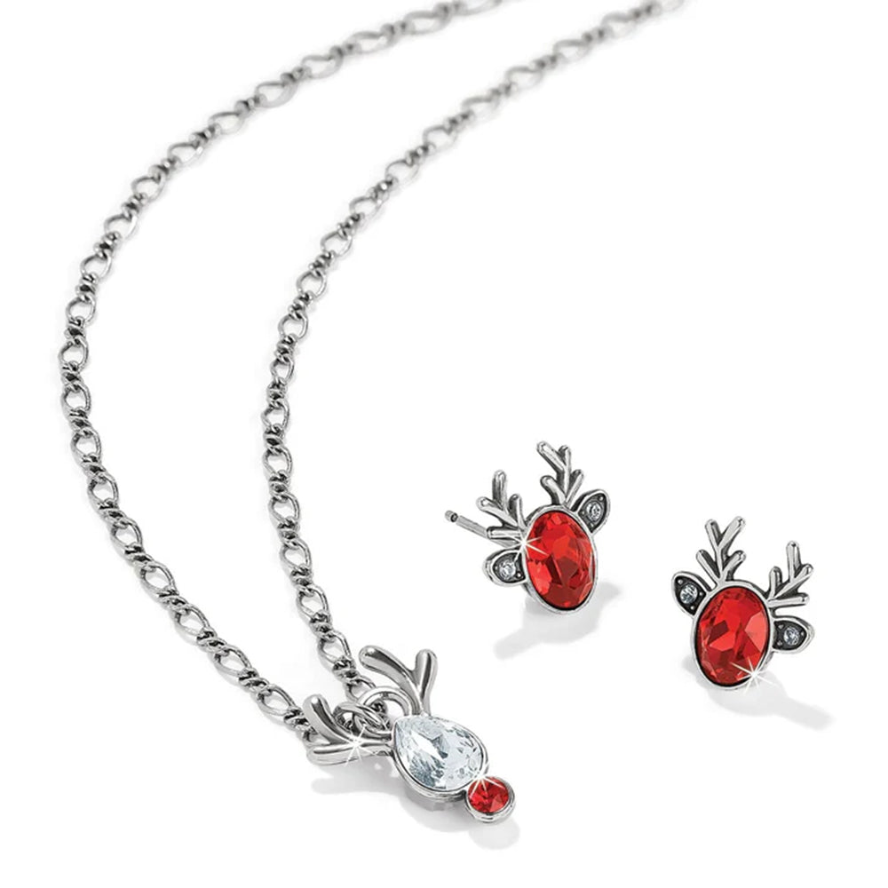 Jewelry set with red gemstones and silver chains on a white background