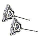 Pair of silver earrings with heart and triangle design on a white background