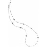 A delicate silver necklace featuring small, alternating polished and textured oval beads, displayed on a clean white background.