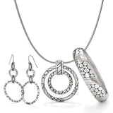 Silver jewelry set including a necklace, pendant, earrings, and cylindrical piece on a white background