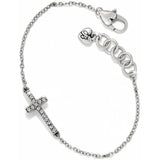 Silver bracelet with a cross charm on a white background
