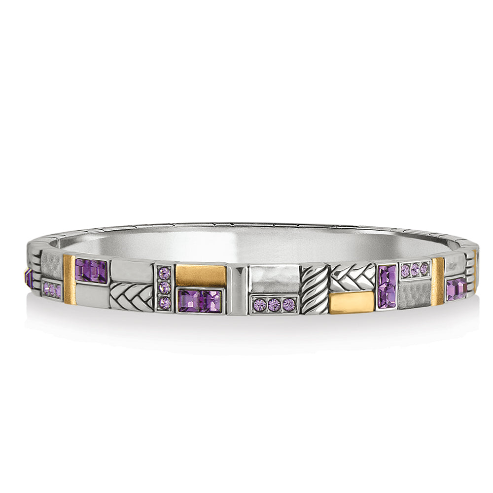 Silver bracelet with gold and purple gemstones on a white background