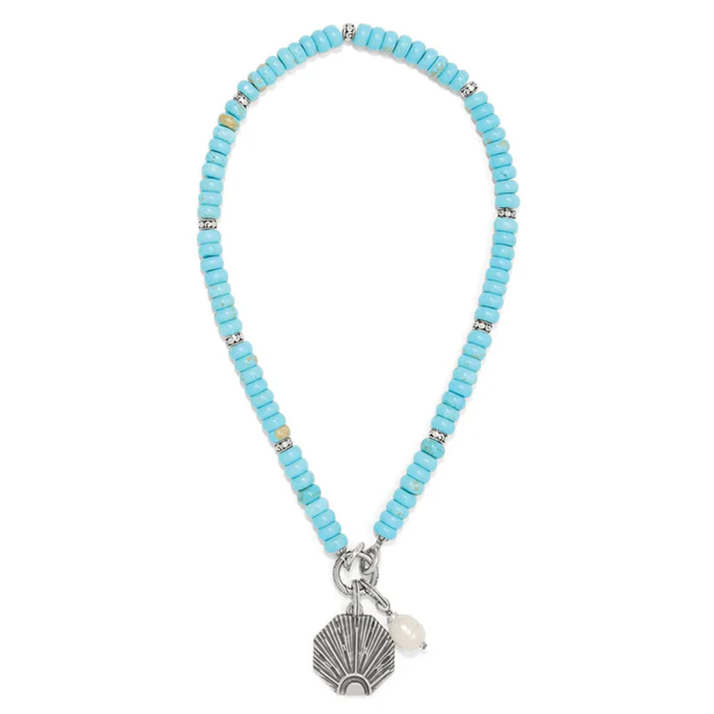Turquoise beaded necklace with a silver and pearl charm on a white background