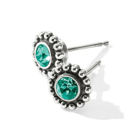 Silver earrings with green gemstones on a white background