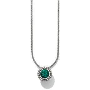 A Brighton Twinkle Emerald Necklace with a green stone set in a circular frame, attached to a silver chain.