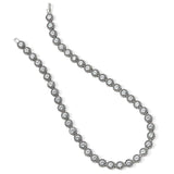 Silver necklace with clear stones on a white background