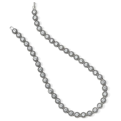 Silver necklace with clear stones on a white background