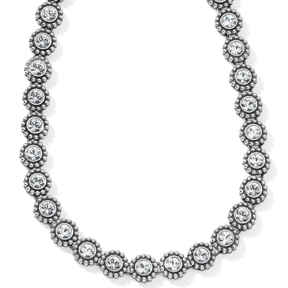 Silver necklace with clear gemstones on a white background