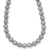 Silver necklace with clear gemstones on a white background
