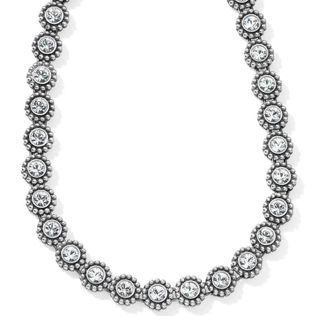 Silver necklace with clear gemstones on a white background