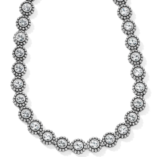 Silver necklace with clear gemstones on a white background