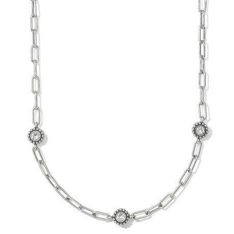 Silver chain necklace with diamond-like pendants on a white background