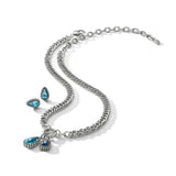 A silver-toned chain necklace with three teardrop-shaped blue gemstone pendants, displayed on a clean white background.