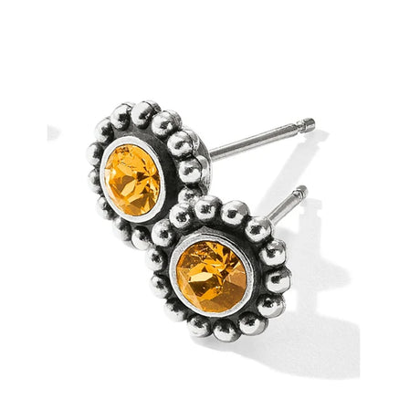 Silver earrings with yellow gemstones on a white background