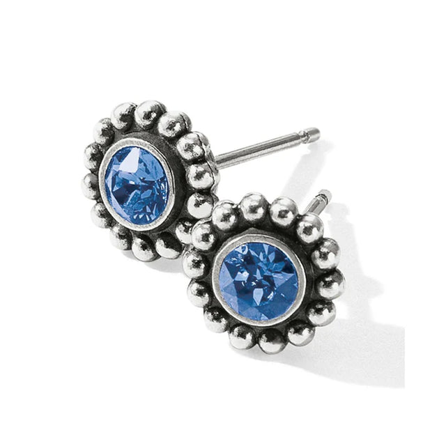 Silver earrings with blue gemstones on a white background