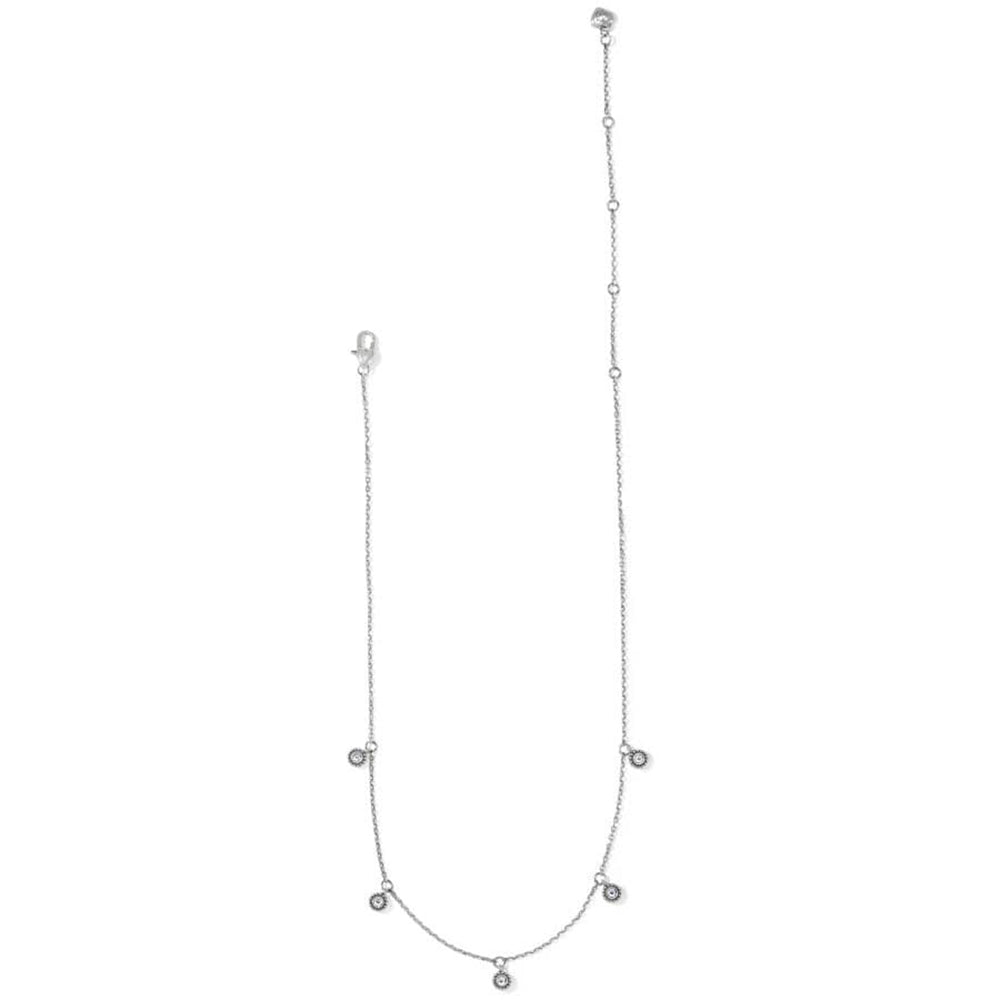 Silver necklace with small round pendants on a white background