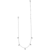 Silver necklace with small round pendants on a white background