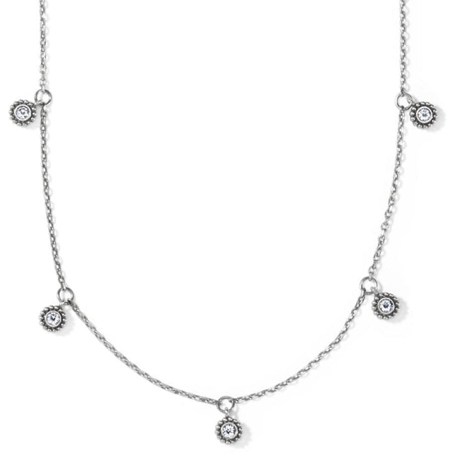 Silver necklace with small circular pendants on a white background