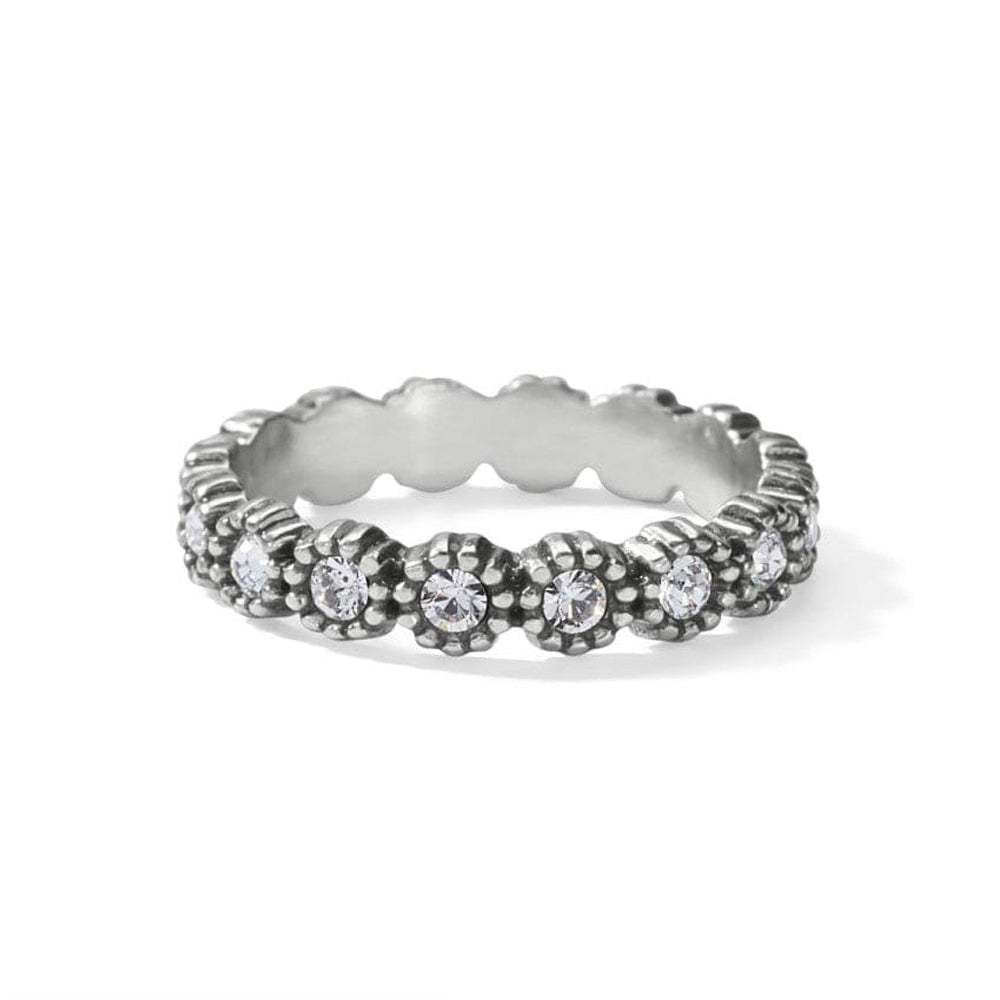 Silver ring with floral design and embedded stones on a white background