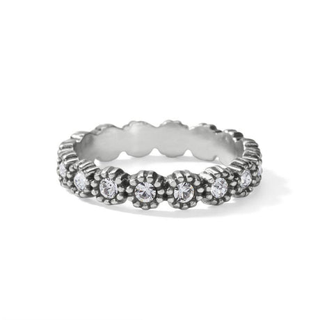 Silver ring with floral design and embedded stones on a white background