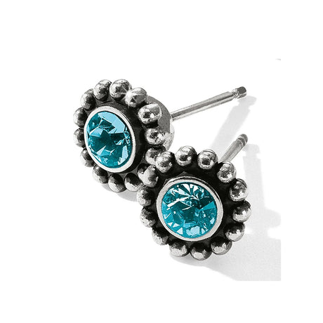Silver earrings with blue gemstones on a white background