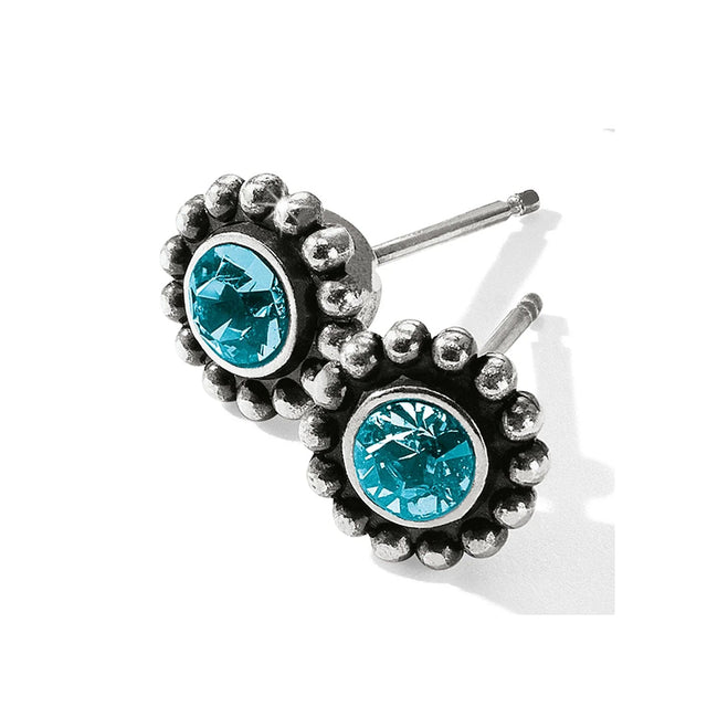 Silver earrings with blue gemstones on a white background