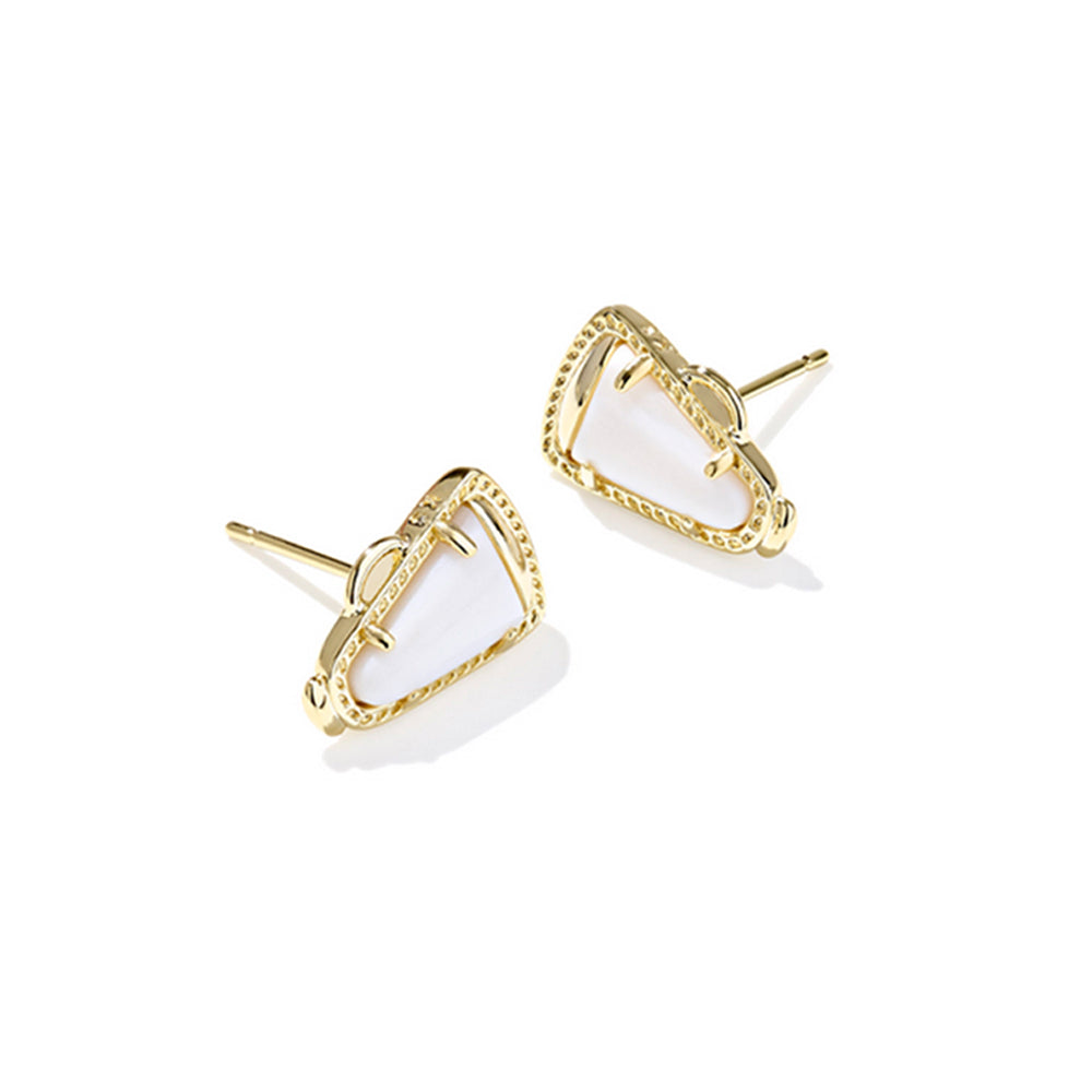 Gold earrings with white stones on a white background