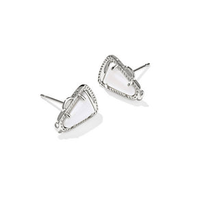 Silver earrings with a white stone on a white background