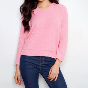 Person wearing a pink sweater and blue jeans on a white background