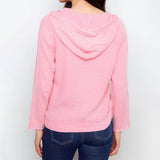 Pink hooded sweater worn by a person on a white background