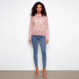 pink crochet sweater hoodie on woman with jeans on