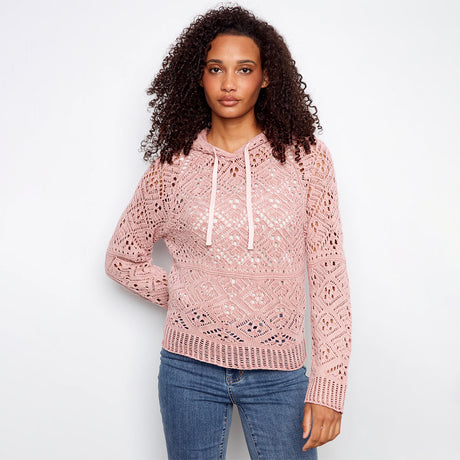 pink crochet sweater hoodie on woman with jeans on