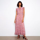 Woman wearing a red floral dress against a white background