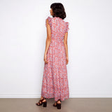 Woman wearing a red floral dress against a white background