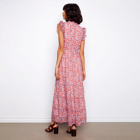 Woman wearing a red floral dress against a white background